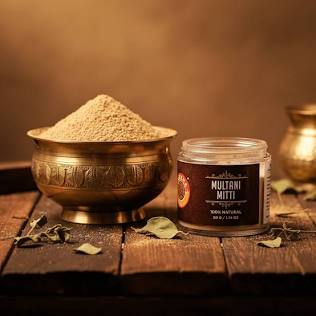 Golden ubtan herbal beauty products in brass bowl at Indora Organic, Bundi